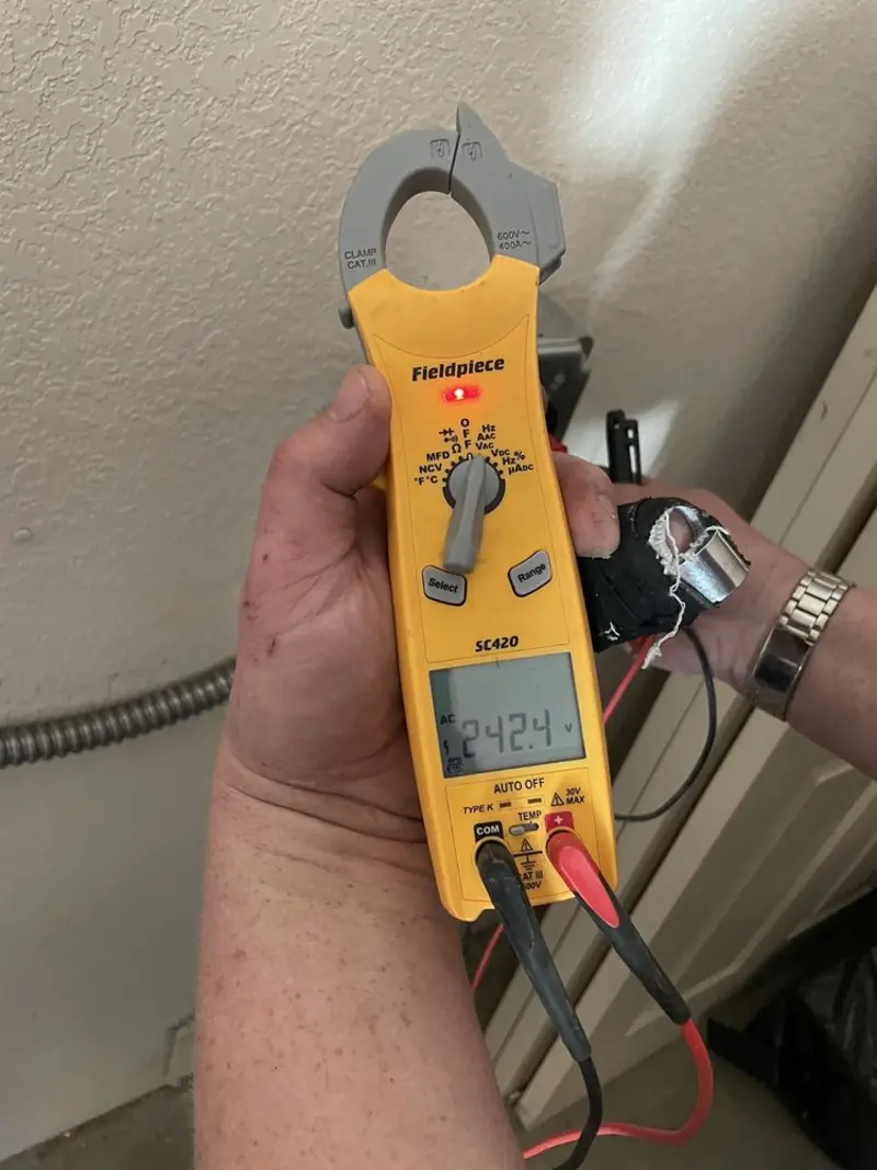 Voltage testing with clamp meter during Whole House Surge Protector in Virginia Beach